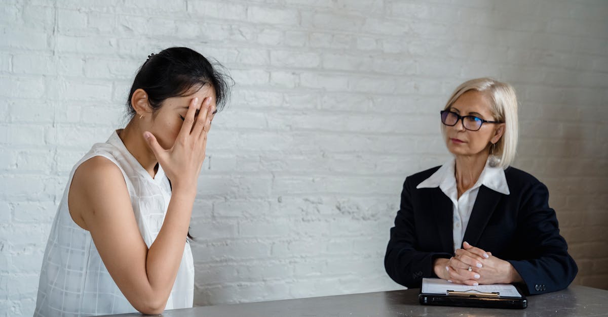 A therapist listens to a patient in an office during a counseling session.